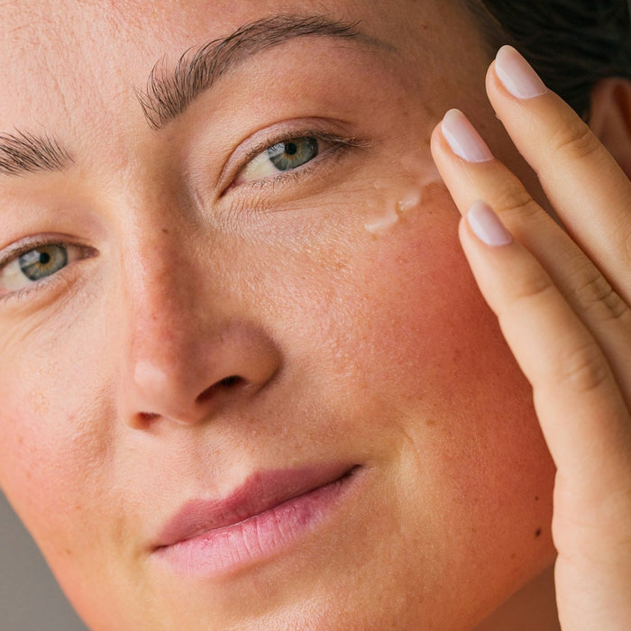 woman applying retinol
